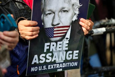 A supporter of WikiLeaks founder Julian Assange holds a sign, on the day the High Court is set to rule on whether Julian Assange can appeal against extradition from Britain to the United States, in London, Britain, March 26, 2024.