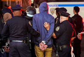 Police detain a protestor, as other police officers enter the campus of Columbia University, during the ongoing conflict between Israel and the Palestinian Islamist group Hamas, in New York City, U.S., April 30, 2024.