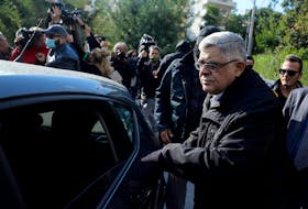Leader of the far-right Golden Dawn party Nikos Mihaloliakos is escorted as he leaves his home, after the party was declared a criminal organisation by a court in Athens, Greece, October 22, 2020.
