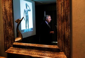 Gian Mario Spacca, then president of the Italian region of Marche, is seen reflected in a mirror while being interviewed after speaking about the ongoing dispute with J. Paul Getty Museum relating to the statue "Victorious Youth," also known as "Atleta di Fano" in Los Angeles, March 28, 2011.