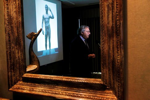 Gian Mario Spacca, then president of the Italian region of Marche, is seen reflected in a mirror while being interviewed after speaking about the ongoing dispute with J. Paul Getty Museum relating to the statue "Victorious Youth," also known as "Atleta di Fano" in Los Angeles, March 28, 2011.