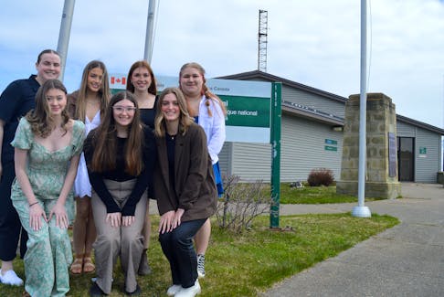 Members of the Glace Bay High School Interact Club stand outside the Marconi National Historic Site in the Table Head neighbourhood of Glace Bay on Tuesday. The group — front, from left, Holly Wells, Mya MacKinnon and Cloe Maxner; and back, from left, Katie Poirier, Grace Halfyard, Mya McFadgen and Olivia Wheaton — won $2,000 for their presentation on the work of Guglielmo Marconi. Chris Connors/Cape Breton Post