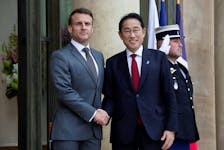 French President Emmanuel Macron welcomes Japan's Prime Minister Fumio Kishida as he arrives for a meeting at the Elysee Palace in Paris, France, May 2, 2024.