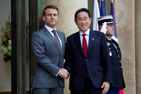 French President Emmanuel Macron welcomes Japan's Prime Minister Fumio Kishida as he arrives for a meeting at the Elysee Palace in Paris, France, May 2, 2024.