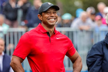 Dec 17, 2023; Orlando, Florida, USA;  Tiger Woods smiles before he plays his shot from the first tee during the PNC Championship at The Ritz-Carlton Golf Club. Mandatory Credit: Reinhold Matay-USA TODAY Sports/File Photo