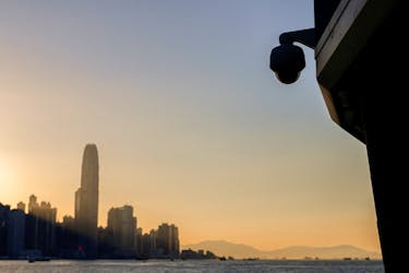 A surveillance camera is seen by the waterfront as skyline buildings stand across Victoria Harbor, in Hong Kong, China October 24, 2023.