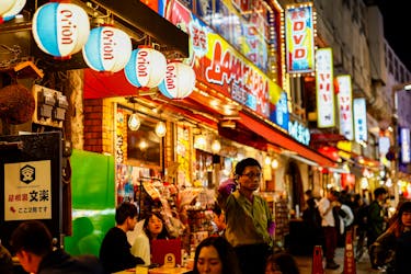 People enjoy drinks and food at izakaya pub restaurants at the Ameyoko shopping district, in Tokyo, Japan February 15, 2024.