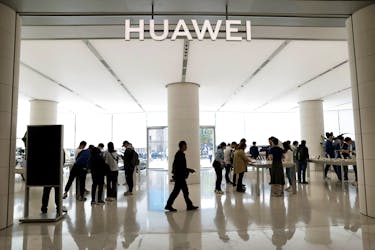 Customers shop at a Huawei's flagship store, as Huawei Pura 70 series models go on sale, in Beijing, China April 18, 2024.