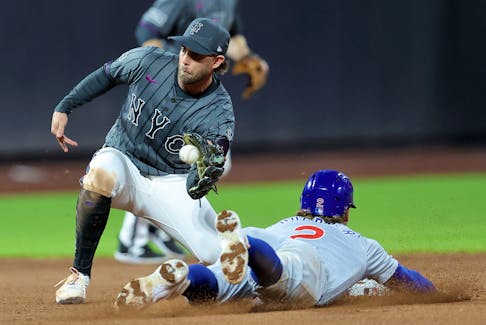 May 1, 2024; New York City, New York, USA; Chicago Cubs second baseman Nico Hoerner (2) steals second base ahead of a tag by New York Mets second baseman Jeff McNeil (1) during the eighth inning at Citi Field. Mandatory Credit: Brad Penner-USA TODAY Sports