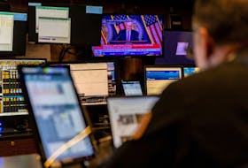 A trader works inside a booth, as screens display a news conference by Federal Reserve Board Chairman Jerome Powell following the Fed rate announcement, on the floor of the New York Stock Exchange (NYSE) in New York City, U.S., May 1, 2024.