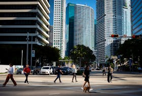 File photo: People cross the intersection of SW 8th Steet and Brickell Ave. at the Brickell neighborhood, known as the financial district, in Miami, Florida, U.S., February 23, 2023.