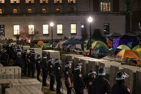 Police stand guard near an encampment of protesters supporting Palestinians on the grounds of Columbia University, during the ongoing conflict between Israel and the Palestinian Islamist group Hamas, in New York City, U.S., April 30, 2024.