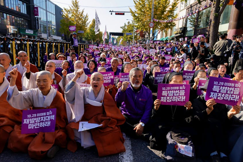 Clerics and families of victims who have died in the Halloween crowd crush a year ago, shout slogans during a rally to commemorate one year anniversary of deadly Halloween crowd crush, at Seoul City Hall Plaza in Seoul, South Korea, October 29, 2023.