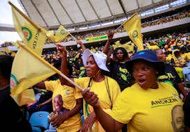 Supporters wave flags at the African National Congress Election Manifesto launch in Durban, South Africa, February 24, 2024.