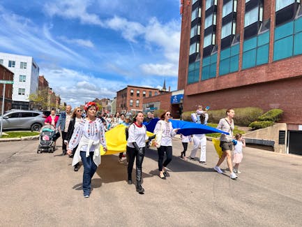 Members of the P.E.I. Ukrainian community walk down Queen Street to Charlottetown's waterfront, chanting and singing on May 18 for Vyshyvanka Day, an annual event to celebrate Ukrainian culture and heritage. Vivian Ulinwa • The Guardian