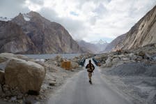 An Indian security personnel stands guard near the Siachen base camp road, in Ladakh's remote Warshi village, home to just one family and five eligible voters, in the Ladakh region, India, May 20, 2024.