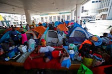 Haitian asylum seekers set up camp in an abandoned gas station while they wait to attempt to cross into the U.S. by an appointment through the Customs and Border Protection app, called CBP One, at a makeshift camp, in Matamoros, Mexico June 21, 2023.