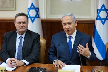 Israeli Prime Minister Benjamin Netanyahu sits next to acting foreign minister Israel Katz, who also serves as intelligence and transport minister, during the weekly cabinet meeting in Jerusalem February 24, 2019. Abir Sultan/Pool via