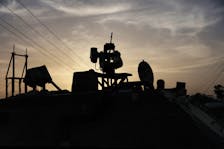 An Israeli solider is silhouetted inside an armored personnel carrier, as military operations continue in the southern Gaza city of Rafah, at an area outside Kerem Shalom, Israel, May 17, 2024.