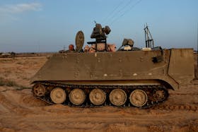 An Israeli solider drives an armored personnel carrier, as military operations continue in the southern Gaza city of Rafah, at an area outside Kerem Shalom, Israel, May 17, 2024.