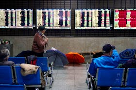 Investors look at screens showing stock information at a brokerage house in Shanghai, China January 16, 2020.