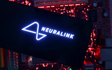 A smartphone with a Neuralink logo displayed is placed on a computer motherboard in this illustration taken on May 15, 2024.
