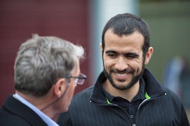 Omar Khadr smiles at his lawyer Dennis Edney (L) as he answers questions during a news conference after being released on bail in Edmonton, Alberta, May 7, 2015. Khadr, a Canadian, was once the youngest prisoner held on terror charges at Guantanamo Bay.    