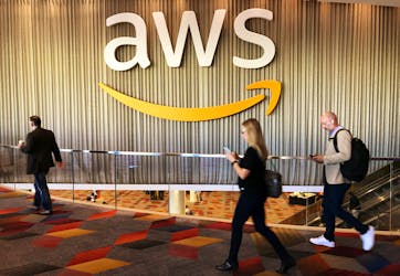 Attendees at Amazon.com Inc annual cloud computing conference walk past the Amazon Web Services logo in Las Vegas, Nevada, U.S., November 30, 2017.   