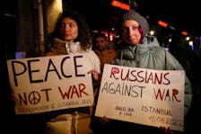 People hold anti-war placards before a rap concert for Ukraine by Russian rapper Oxxxymiron, amid the Russian invasion of Ukraine, in Istanbul, Turkey March 15, 2022.