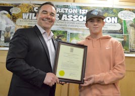 Taylor Blunden, right, accepts the Licence of a Lifetime certificate from Nova Scotia Department of Fisheries and Aquaculture Minister Kent Smith during a presentation at ACAP Cape Breton in Sydney. The annual draw gives the winner a free general fishing licence, small game hunting licence and either a deer hunting, bear hunting, bear snaring or fur harvester licence for the rest of their life. Blunden, a 16-year-old Dutch Brook resident, has been hunting and fishing since he was seven years old. “It makes me connect with nature a lot I find when I'm just sitting in the woods even,” he said. Chris Connors/Cape Breton Post