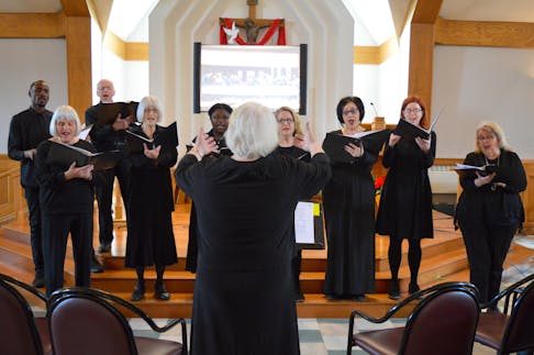 Musical director Rosemary McGhee conducts singers Joseph Chaninomi, from left, Claire Rogers, Bernard LeVert, Mary Jane Ross, Chimango Mkandawike, Melissa MacNeil, Ainslie MacLean, Emma Francis and Ruth Ann Morrison as the Knights of Columbus Council 9476 presented Project 3.16 at St. Marguerite Bourgeoys Parish in Sydney on Sunday. Based on the Bible verse John 3.16 (“For God so loved the world that he gave his one and only Son, that whoever believes in him shall not perish but have eternal life”), the project combined the music of  Bach and St. Matthew Passion with the artwork of da Vinci, Caravaggio and others to tell the story of the Easter season. Chris Connors/Cape Breton Post