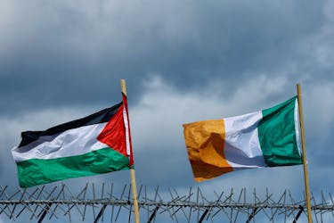 Flags of Palestine and Ireland flutter next to each other over the International Wall in support of Gaza, amid the ongoing conflict between Israel and the Palestinian Islamist group Hamas, in Belfast, Northern Ireland, March 29, 2024.