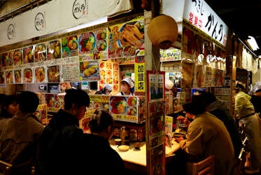People have lunch at a seafood restaurant at Tsukiji Outer Market in Tokyo, Japan, February 15, 2024. 