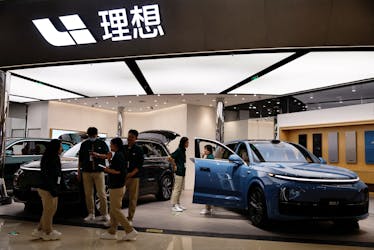 Staff members stand at the booth of Chinese electric vehicle (EV) maker Li Auto, at a shopping mall in Beijing, China November 3, 2023.