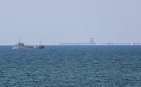 A ship loaded with aid sails near a U.S.-built pier, amid the ongoing conflict between Israel and the Palestinian Islamist group Hamas, as seen from central Gaza Strip, May 18, 2024.