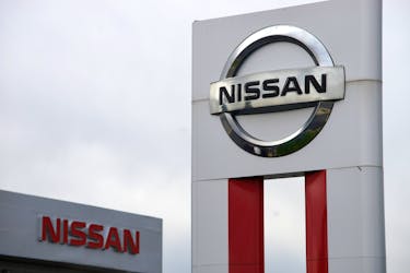 Nissan signs are seen outside a Nissan auto dealer in Broomfield, Colorado October 1, 2014. 