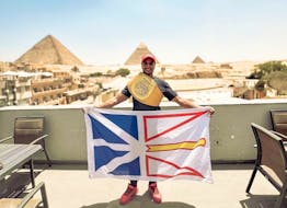 St. John’s and Egyptian kickboxer Hady Ghoneim poses with the province’s flag and the WAKO Canadian championship belt in front of the pyramids of Giza during a recent home trip to Egypt. It was the first time in seven years that Ghoneim had been home. Contributed photo