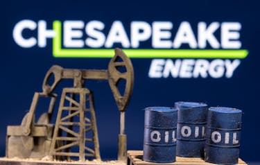 A 3D printed oil barrels and oil pump jack are seen in front of displayed Chesapeake Energy logo in this illustration taken January 25, 2022.