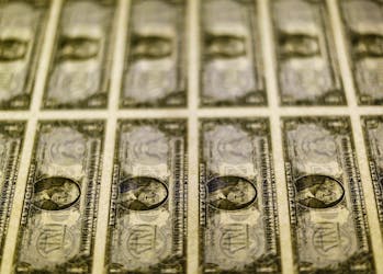 United States one dollar bills are seen on a light table at the Bureau of Engraving and Printing in Washington in this November 14, 2014.