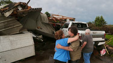 June Handsaker consoles his brother Larry Handsaker after a tornado damaged his house in Nevada, Iowa, U.S. May 21, 2024. Nirmalendu Majumdar/Ames Tribune/USA Today Network via REUTERS