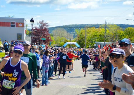 A runners’ view of how it looks like in the final hundred metres of the 2022 Cabot Trail Relay race. The runners were greeted by a large and enthusiastic crowd in the centre of Baddeck where the race ended Sunday morning. More than 1,000 runners from 63 teams took part in the annual competition that returned for the first time since 2019. DAVID JALA/CAPE BRETON POST