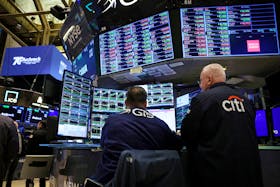 Traders work on the floor at the New York Stock Exchange (NYSE) in New York City, U.S., April 26, 2024. 