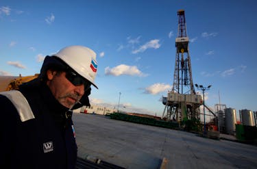 A worker stands near a drilling rig at Grabowiec 6 near the village of Lesniowice, southeast Poland, home to U.S. giant Chevron's first shale gas well in the country, November 28, 2011.