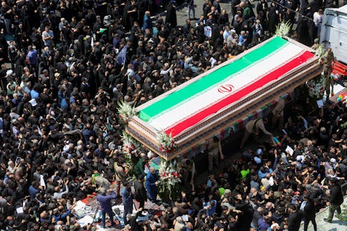Mourners attend the funeral for victims of helicopter crash that killed Iran's President Ebrahim Raisi, Foreign Minister Hossein Amirabdollahian and others, in Tehran, Iran, May 22, 2024. Majid Asgaripour/WANA (West Asia News Agency) via