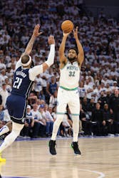 May 22, 2024; Minneapolis, Minnesota, USA; Minnesota Timberwolves center Karl-Anthony Towns (32) shoots against Dallas Mavericks center Daniel Gafford (21) in the fourth quarter during game one of the western conference finals for the 2024 NBA playoffs at Target Center. Mandatory Credit: Jesse Johnson-USA TODAY Sports