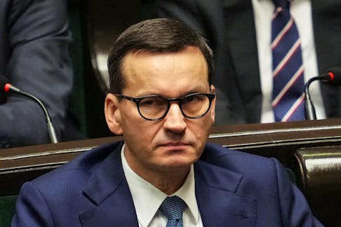 Former Polish Prime Minister Mateusz Morawiecki looks on as Prime Minister Donald Tusk (not pictured) presents his government's programme and asks for a vote of confidence in Parliament in Warsaw, Poland December 12, 2023.