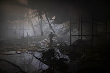 A firefighter works at the site where a printworks was hit by Russian missile strikes, amid Russia's attack on Ukraine, in Kharkiv, Ukraine May 23, 2024.