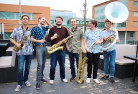 Backhouse Brass share a laugh during a break between sets on the rooftop patio of the Old Triangle on May 10. Pictured here from left are Gabe Sutherland, Cruz Wilson, Nathan Grosset, David Casagrande, Carter Todd and Nathan Trimm. NICOLE SULLIVAN / CAPE BRETON POST