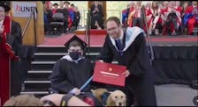 Blair Curtis couldn’t get up on the stage at the University of New Brunswick’s graduation ceremony at the Richard J. Currie Centre in Fredericton on May 16, 2024, due to accessibility issues. Instead, the McIvers man had to cross in front of the stage in his wheelchair with his mobility service dog, DJ. This is the image of him that was seen on the monitors at the ceremony. - Contributed
