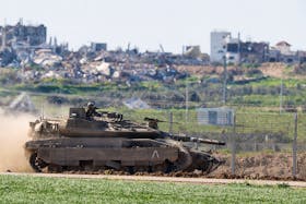 An Israeli military tank drives along the Israel-Gaza border as it returns from the Gaza strip,  amid the ongoing conflict between Israel and Palestinian Islamist group Hamas, in southern Israel, February 29, 2024.